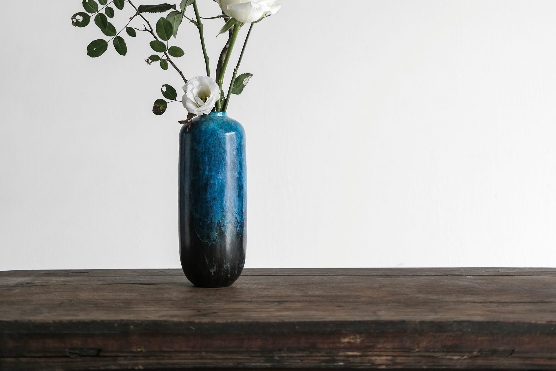 white flowers in blue vase